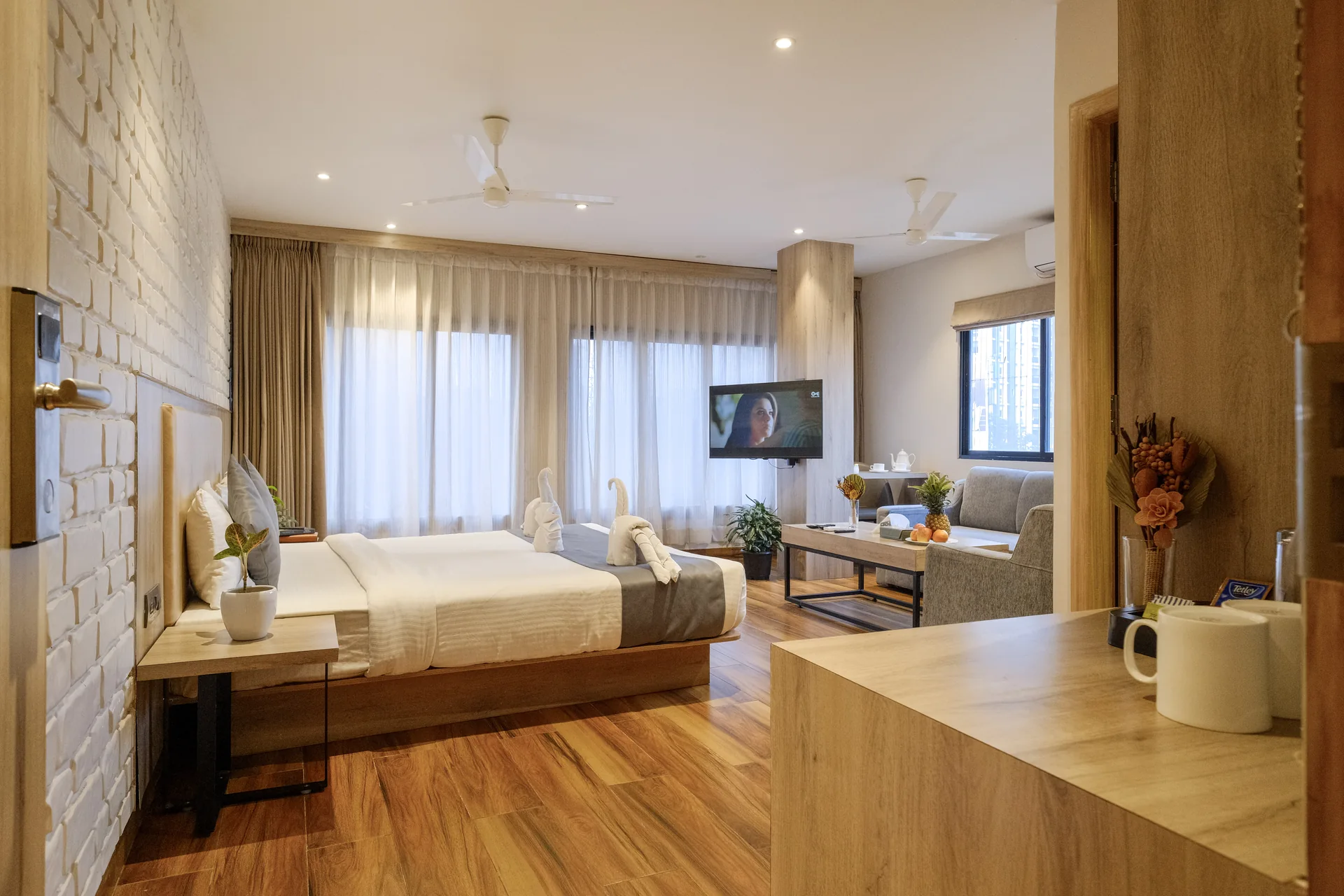 Suite interior with a sofa, coffee table and double bed at Firangipani Ecosuites