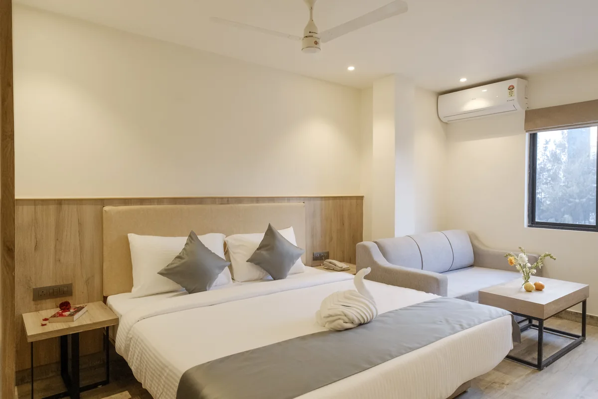 Executive Suite with a double bed, sofa and coffee table at Firangipani Ecosuites