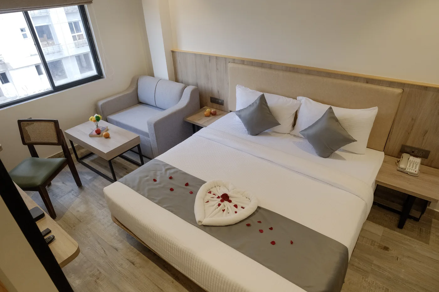 Elevated view of the Junior Suite bed, armchair and coffee table